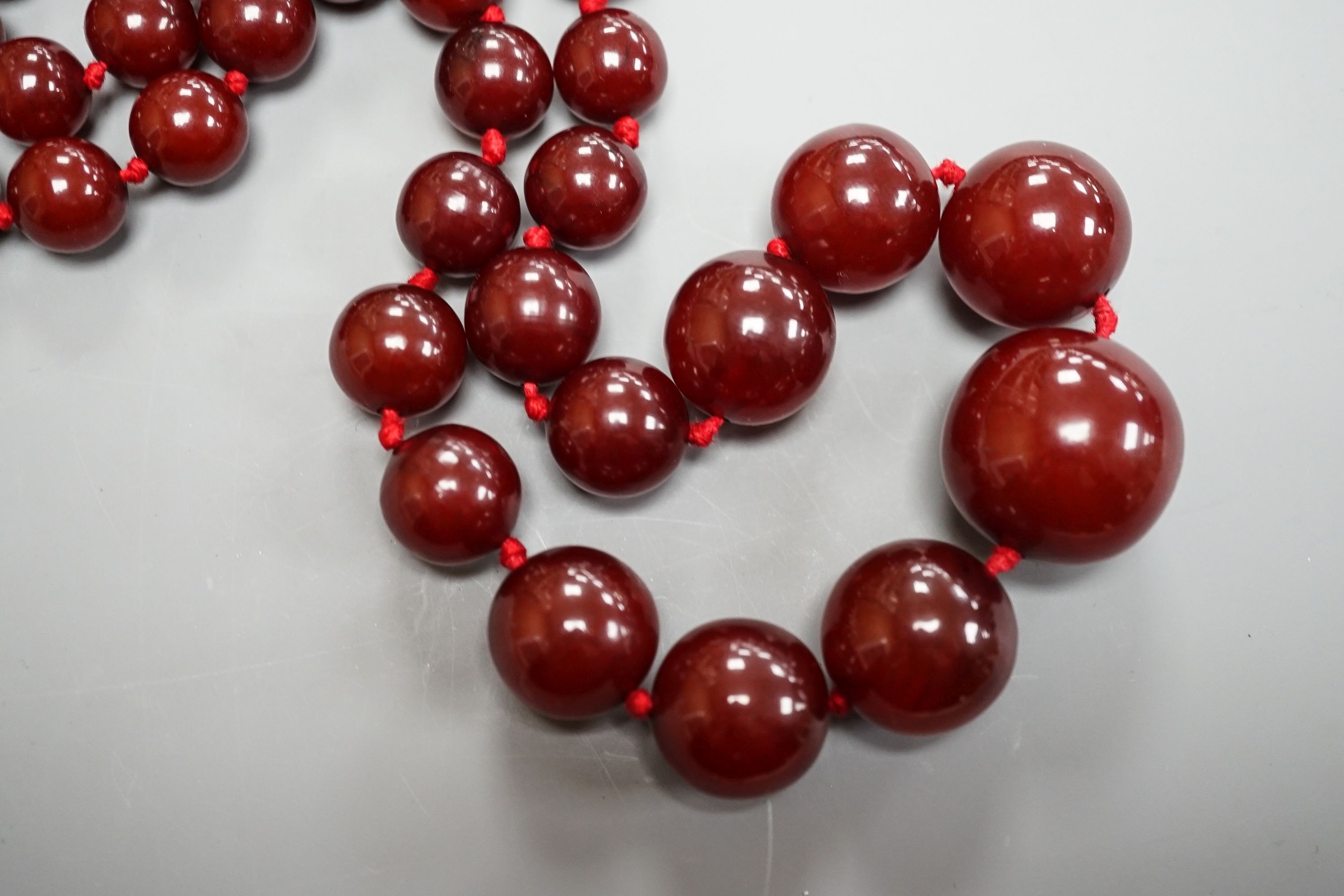 A graduated cherry amber bead necklace, 110cm, gross weight 94 grams.